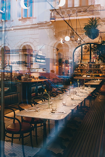 Charming restaurant interior with elegant table settings and warm lighting, perfect for dining. HD phone wallpaper