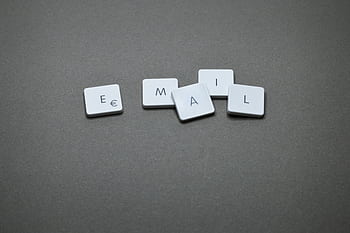 Close-up of the word 'email' formed with letter tiles on a gray surface. HD wallpaper