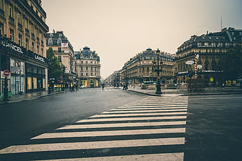 Charming urban scene in an old town with historic buildings and crosswalk in the foreground. HD wallpaper