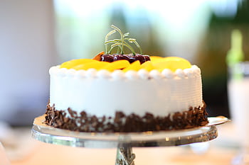 Elegant cake with fruits and chocolate shavings, perfect for celebrations. HD wallpaper