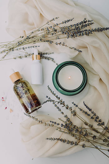 A calming flat lay of spa essentials featuring lavender and candles for relaxation. HD phone wallpaper