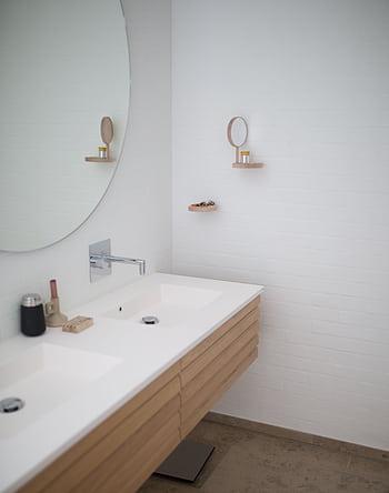 Sleek minimalist bathroom design with double sink and round mirror, showcasing modern interior design. HD phone wallpaper