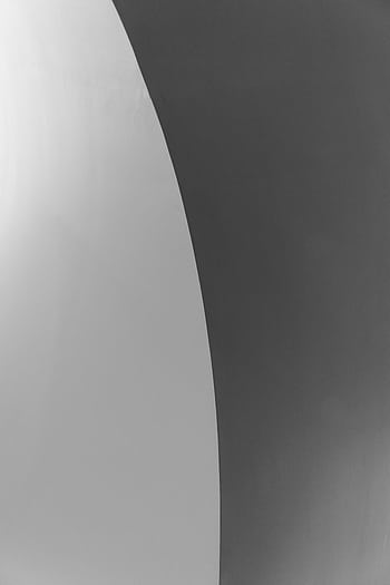 A high contrast black and white abstract featuring smooth curved lines and minimalist design. HD phone wallpaper