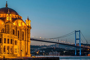 Illuminated Ortaköy Mosque and Bosphorus Bridge overlooking Istanbul's Bosphorus at dusk. HD wallpaper