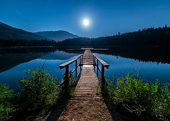 Discover tranquility at a moonlit dock in Whistler, BC, under a starry sky. HD wallpaper