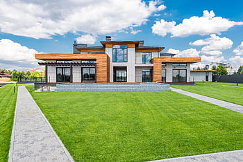 Stunning modern house exterior showcasing spacious lawn and contemporary architecture. HD wallpaper