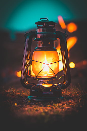 A classic illuminated lantern casting warm glow amidst night setting. HD phone wallpaper