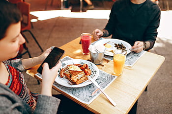 Two people enjoy brunch outdoors in Brazil, captured with a smart and Canon camera. HD wallpaper