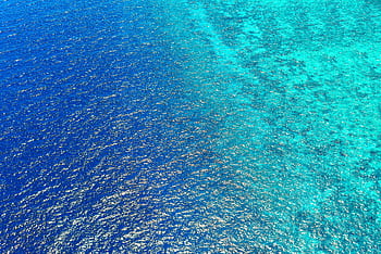 Stunning aerial view capturing the vibrant blue ocean waters of Central Kalimantan, Indonesia. HD wallpaper