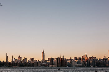 Stunning view of New York City skyline at sunset, featuring the iconic Empire State Building. HD wallpaper