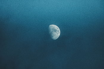 Captivating view of the half moon illuminating a misty, cloudy night sky. HD wallpaper