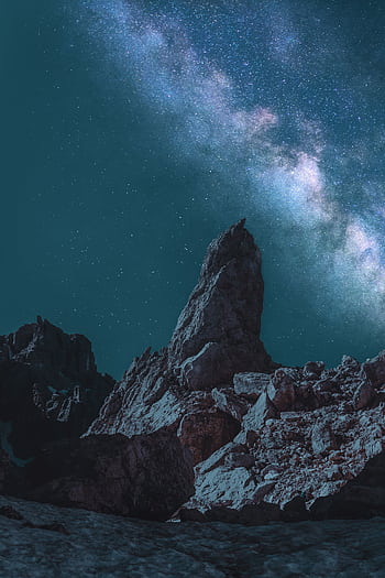 Stunning view of a rocky landscape under a vibrant Milky Way night sky. HD phone wallpaper