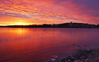 Sunset, sea, city, colors, stones, beach, reflection, clouds, nature, sky HD wallpaper
