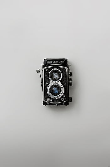 Classic Rolleiflex camera showcased against a simple background, emphasizing nostalgia and vintage design. HD phone wallpaper