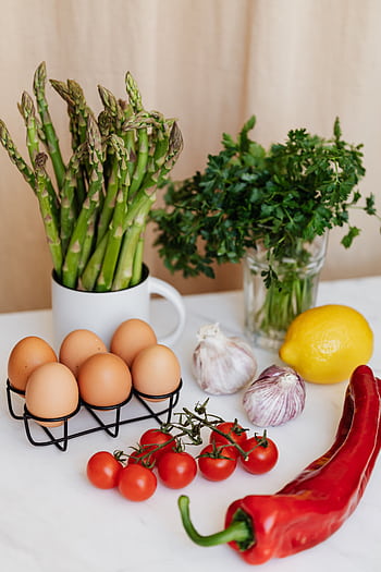 A selection of fresh ingredients including asparagus, eggs, and more for healthy cooking. HD phone wallpaper