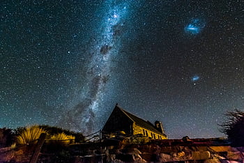 Captivating night sky with Milky Way over a historic church, ideal for astronomy enthusiasts. HD wallpaper