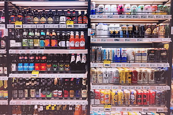 Wide variety of bottled and canned beers displayed on store shelves in Shanghai, China. HD wallpaper