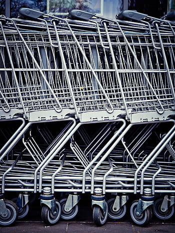 Rows of stacked metal shopping carts forming a repetitive industrial pattern. HD phone wallpaper