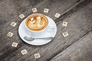 Cup of cappuccino with latte art surrounded by Scrabble letters spelling 'Good Morning'. HD wallpaper