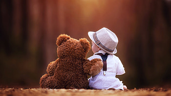 Backside Of Cute Baby Is Wearing White Dress And Hat Sitting With Teddy Bear Cute HD wallpaper