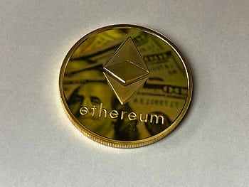Close-up of a shining Ethereum coin reflecting a dollar bill, symbolizing digital currency and wealth. HD wallpaper