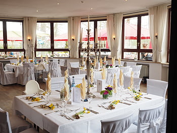 A beautifully arranged dining room with elegant table settings ready for a special event or celebration. HD wallpaper