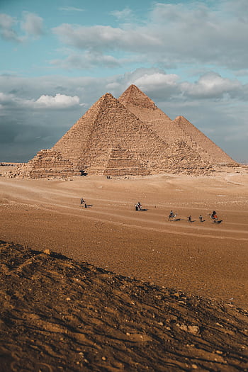 Stunning landscape of the Pyramids of Giza under a blue sky, capturing Egypt's ancient wonder. HD phone wallpaper