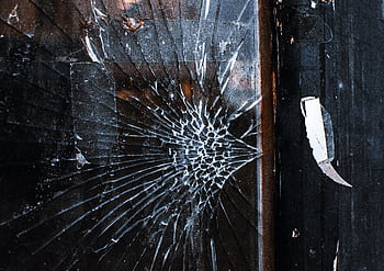 Close-up of a cracked window with a weathered wooden frame and grunge texture. HD wallpaper