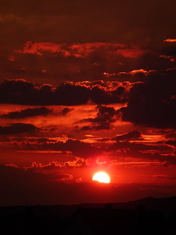 Stunning red sunset with dramatic clouds, capturing scenic beauty. HD phone wallpaper