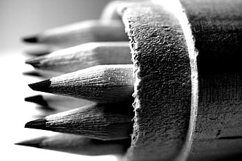Artistic black and white close-up of pencils in a wooden holder showcasing texture and detail. HD wallpaper