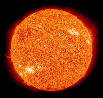 Detailed of the sun showcasing its fiery surface and glowing edges. HD wallpaper