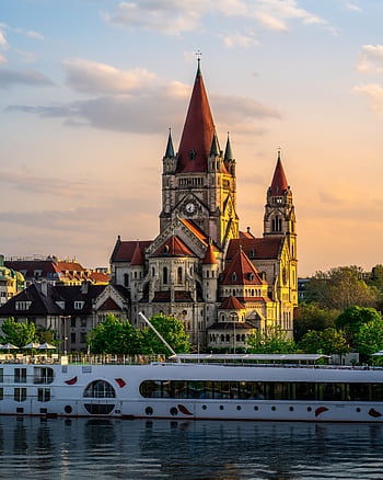 Scenic view of St. Francis of Assisi Church by the river at sunset in Vienna, Austria. HD phone wallpaper