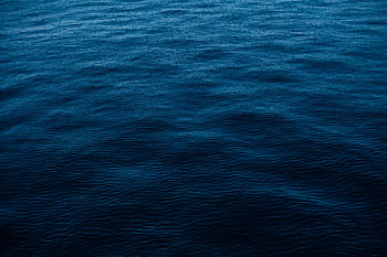 Vivid depiction of deep blue ocean surface, perfect for backgrounds and . HD wallpaper