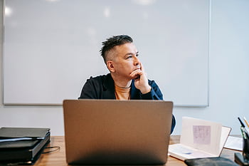 Focused businessman in home office, pondering work thoughts. Perfect for remote work and telecommuting concepts. HD wallpaper