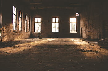 Dilapidated factory interior with sunlight streaming through windows in Rheinsberg, Germany. HD wallpaper