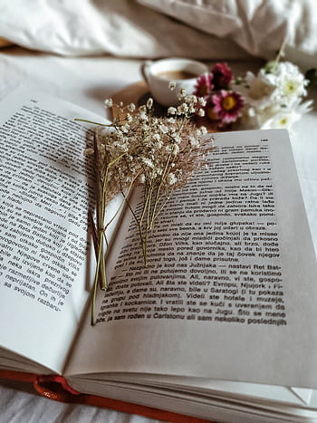 An open book with dried flowers, coffee, and a bouquet creates a serene reading setting. HD phone wallpaper