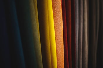 A close-up view of colorful fabric showcasing diverse textures and vibrant folds. HD wallpaper