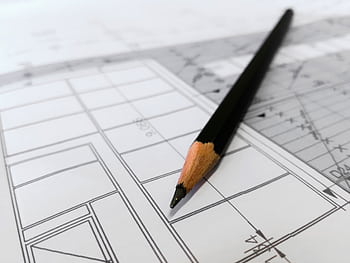 Detailed of a black pencil resting on architectural blueprints, ideal for design and planning themes. HD wallpaper