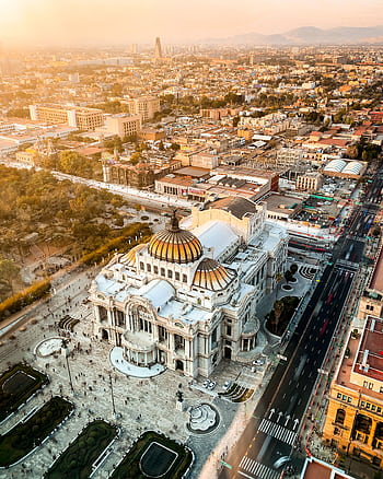 Stunning aerial of Palacio de Bellas Artes in Mexico City at sunset, showcasing urban architecture. HD phone wallpaper