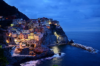 Beautiful night view of the colorful cliffside village of Manarola in Cinque Terre, Italy. HD wallpaper