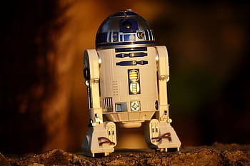 Close-up of a futuristic robot toy outdoors, showcasing its metallic and plastic components. HD wallpaper