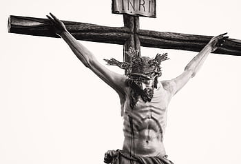Monochrome depiction of Jesus crucified, showcasing religious artistry and sacrifice. HD wallpaper