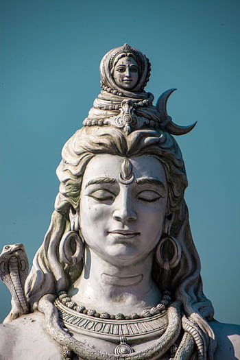 Intricate statue of Lord Shiva with serene expression in Rishikesh, India. HD phone wallpaper