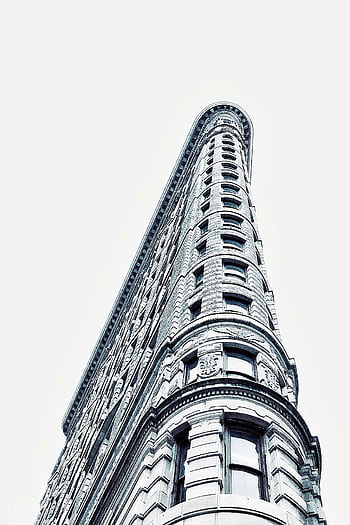 Modern architectural marvel of the Flatiron Building captured from a low angle in New York City. HD phone wallpaper