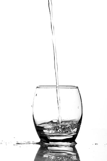 Refreshing of water being poured into a glass, emphasizing purity and clarity. HD phone wallpaper