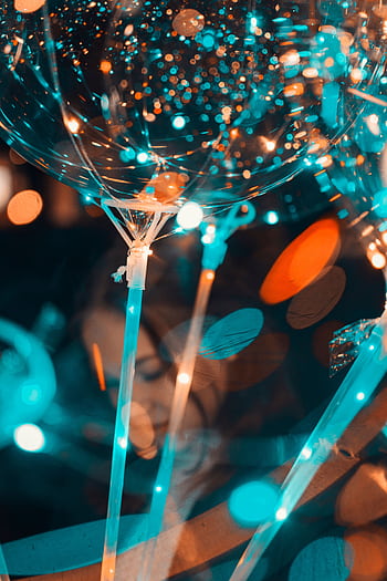 Colorful bokeh effect with balloons and party lights creating a festive atmosphere. HD phone wallpaper