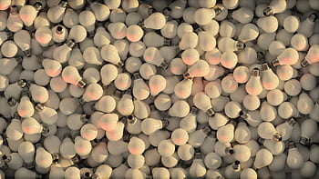 Aerial view of a colorful pile of incandescent light bulbs creating a radiant and dynamic texture. HD wallpaper