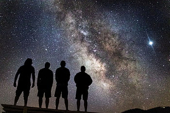 Silhouettes of people stargazing under the clear Milky Way night sky. HD wallpaper