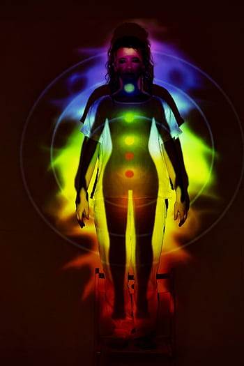 Human silhouette with vibrant chakra energy projection, symbolizing balance and spirituality. HD phone wallpaper