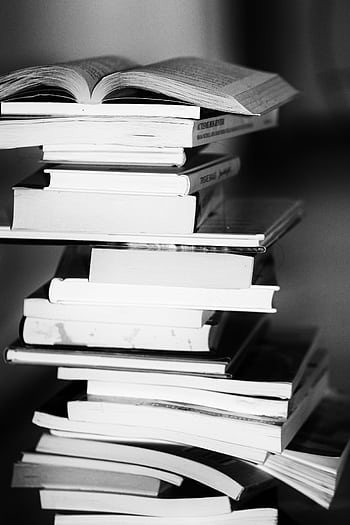 A monochrome of a tall stack of books symbolizing education and knowledge. HD phone wallpaper